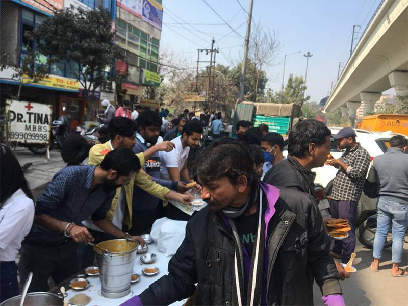 Volunteers distributing food on street
